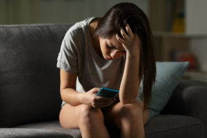 Stressed teen girl on phone